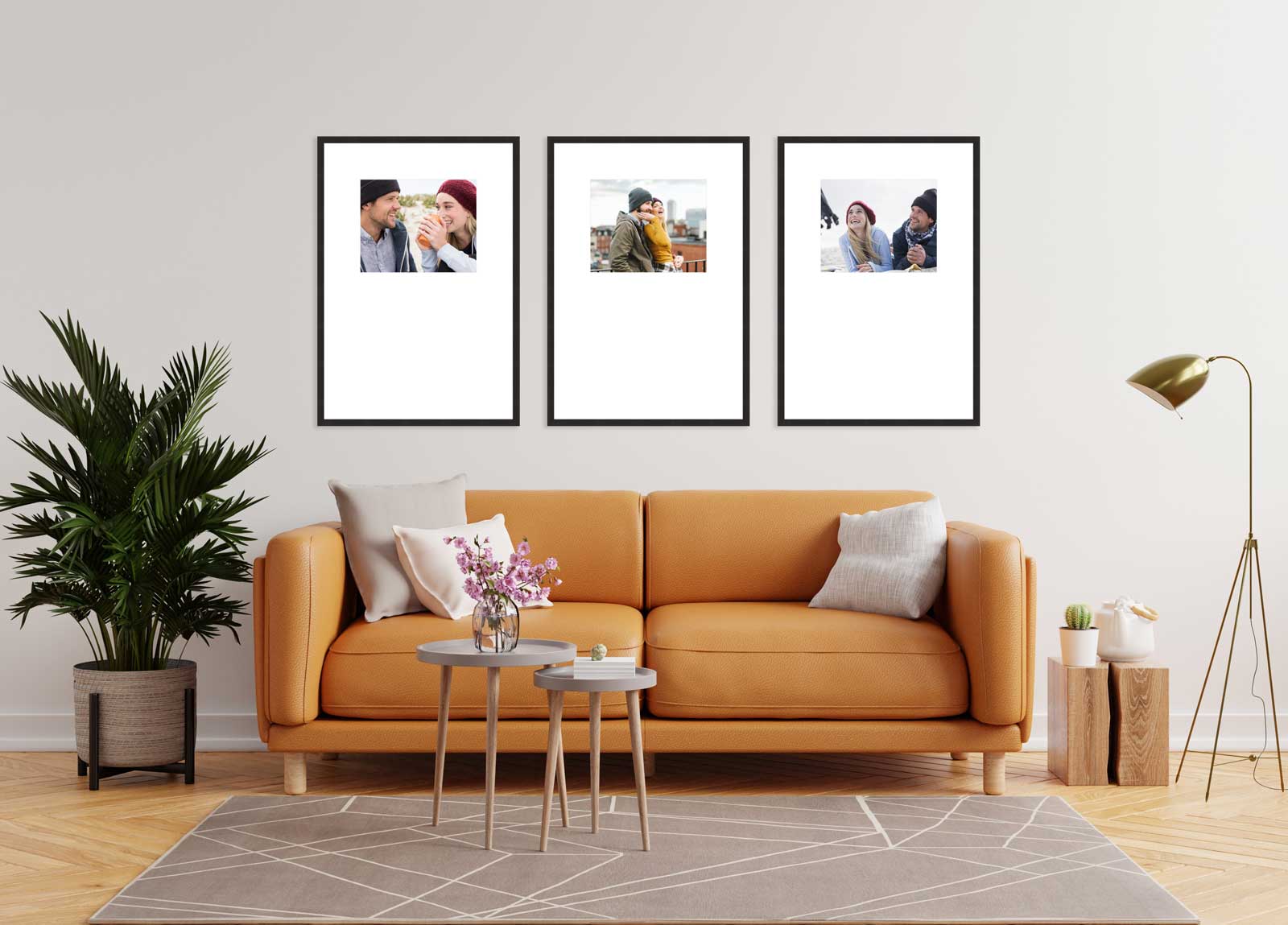 Living room with orange sofa and three framed photos on the wall.
